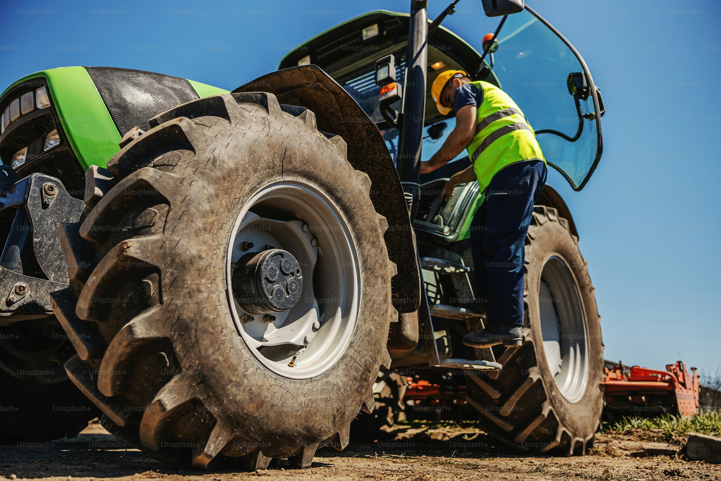 Farmers working in a field under a clear sky